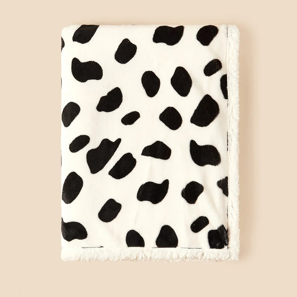 couverture bébé blanche tachetée de noir